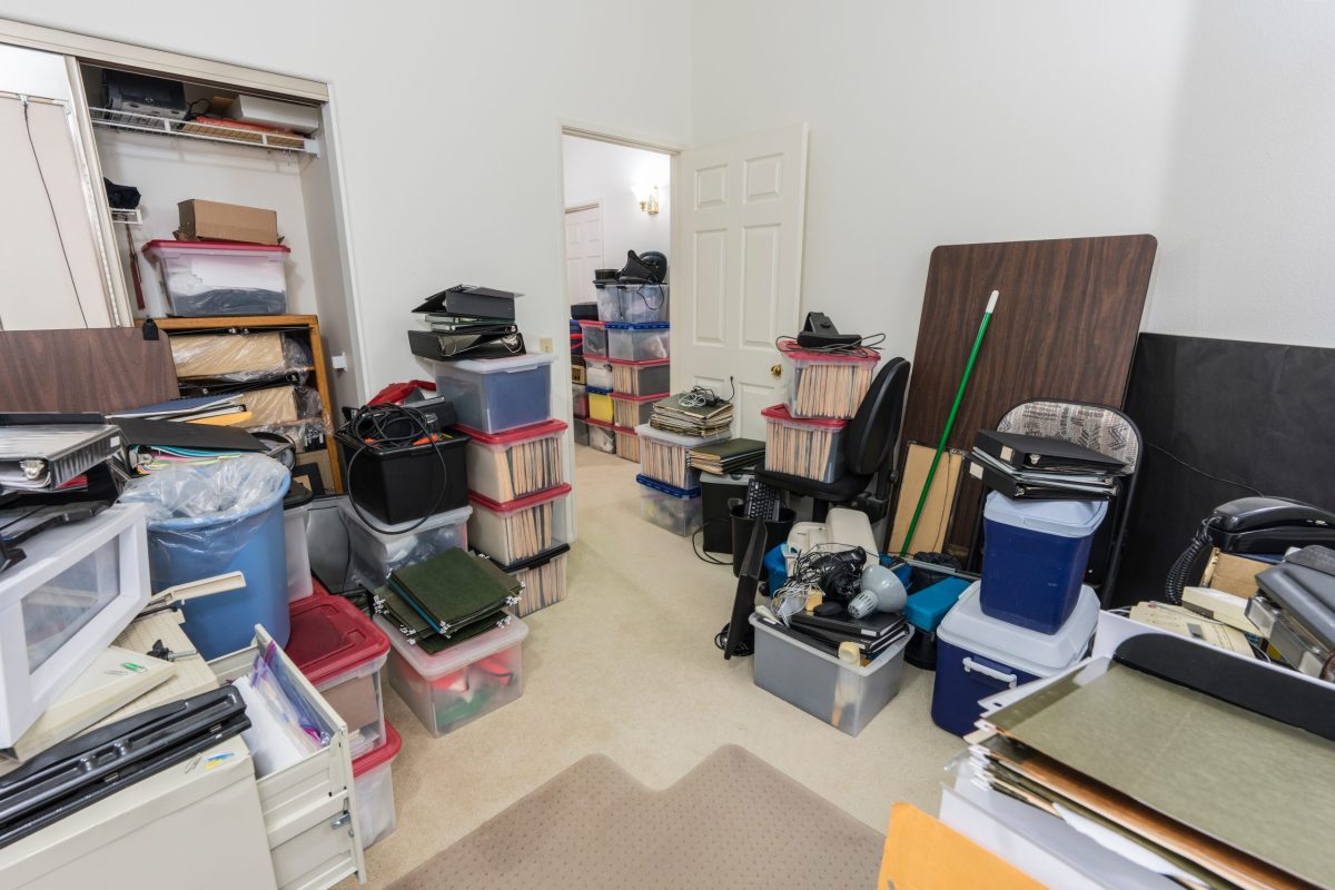 Messy back office with boxes, clutter old equipment and miscellaneous storage.